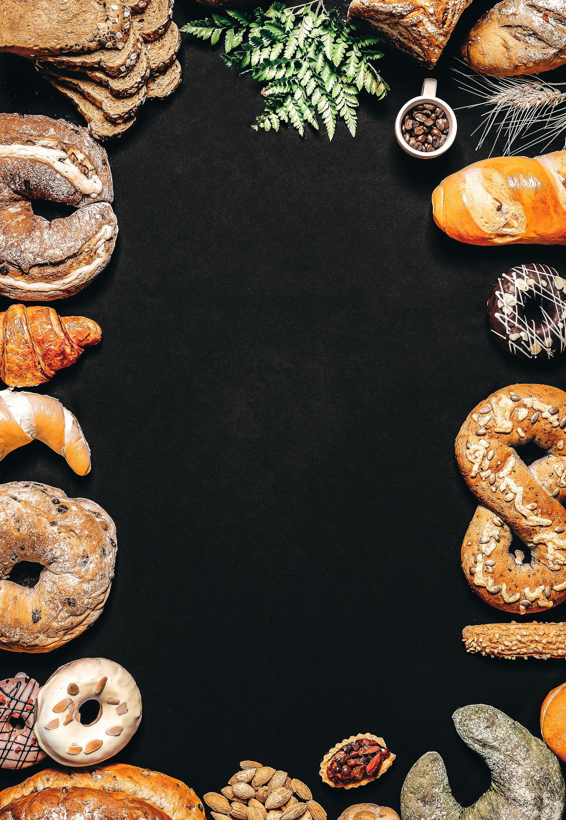 A spread of bagels, croissants, and pretzels seen from above